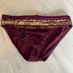 Charlie by MZ Swim Brief 
Size Small
Purple and gold speedo
Brand: Charlie by MZ